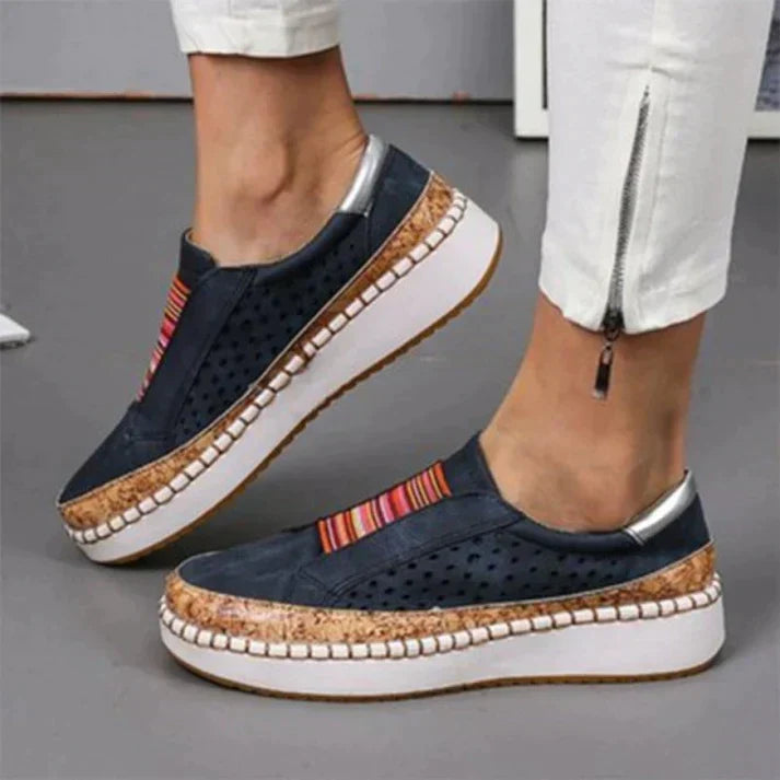 Lightweight women's slip-on walking shoes with a breathable perforated design, offering comfort for daily activities.