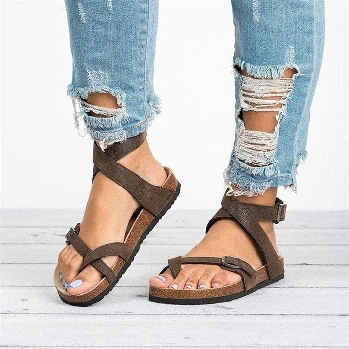 Women's comfortable strappy flat sandals for everyday wear. Features adjustable straps & breathable design.