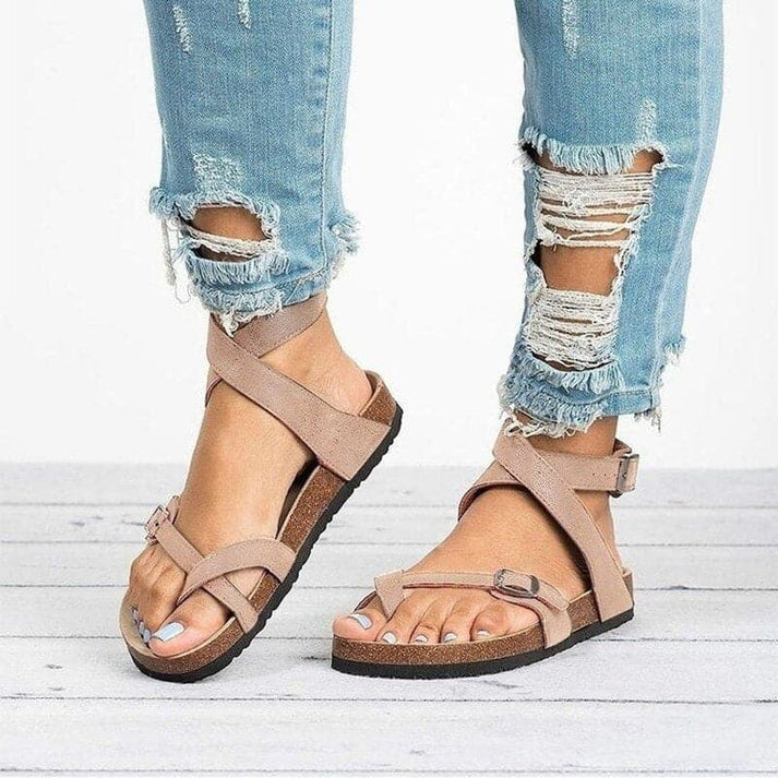 Breathable women's flat sandals with comfortable strappy design, ideal for casual summer style.