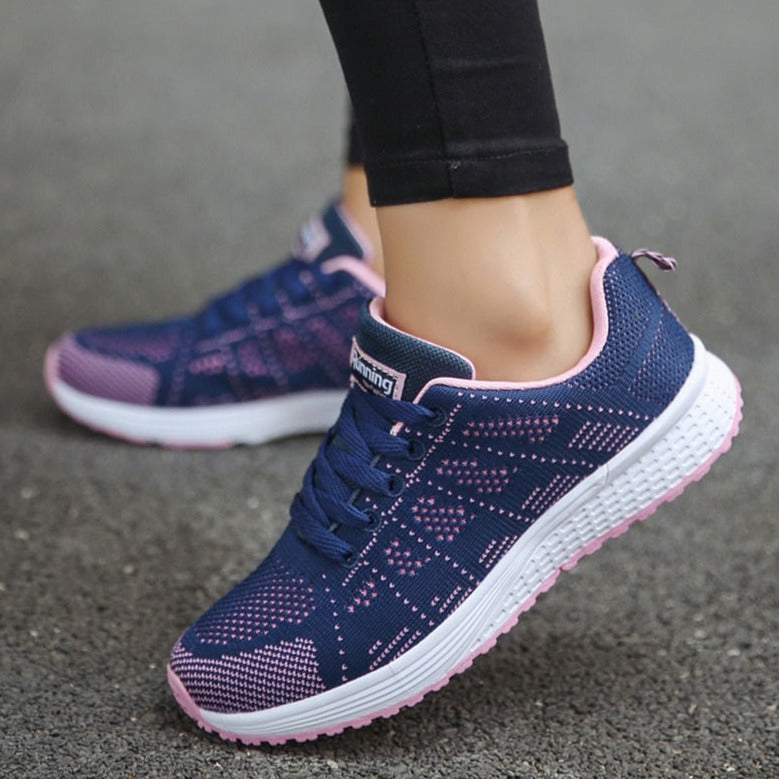 Close-up of women's comfortable walking shoes, showcasing breathable mesh & arch support sole.