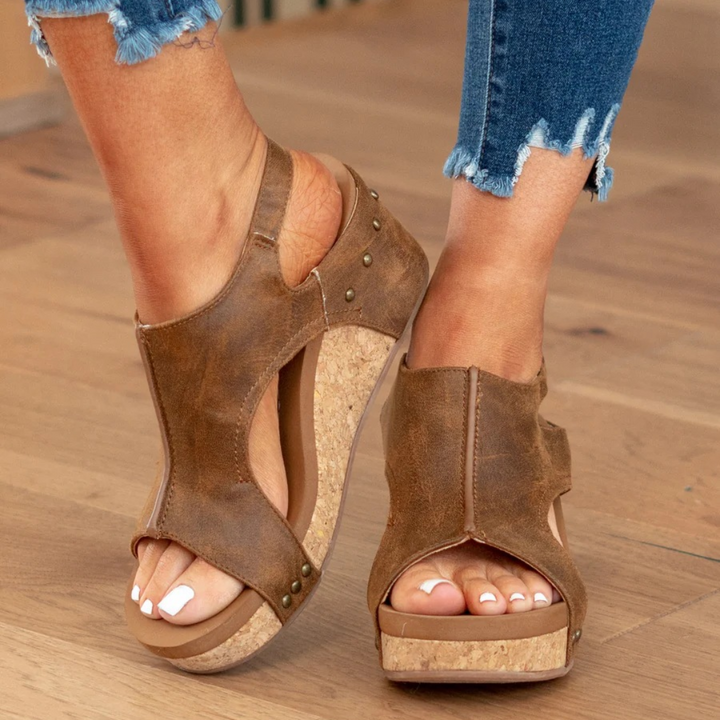 Women's wedge sandals showcasing support. Effortless slip-on design, comfortable and chic for any casual event.