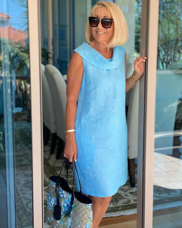 Stylish women's sleeveless cowl neck shift dress. Relaxed fit, perfect for summer, vacation, or brunch outfits. With pockets.