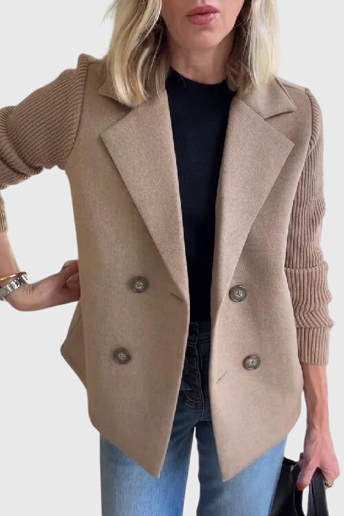 Close-up of a women's tailored double-breasted blazer featuring soft fabric and elegant contrast sleeves.