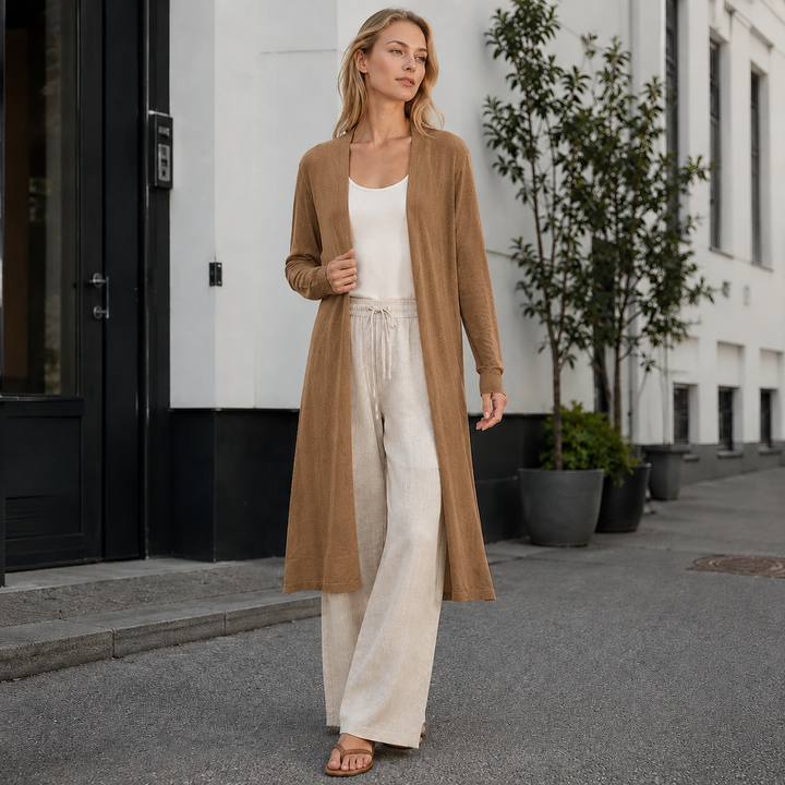 Close-up of the soft, chunky knit texture of a women's cozy long cardigan. Perfect for comfort.
