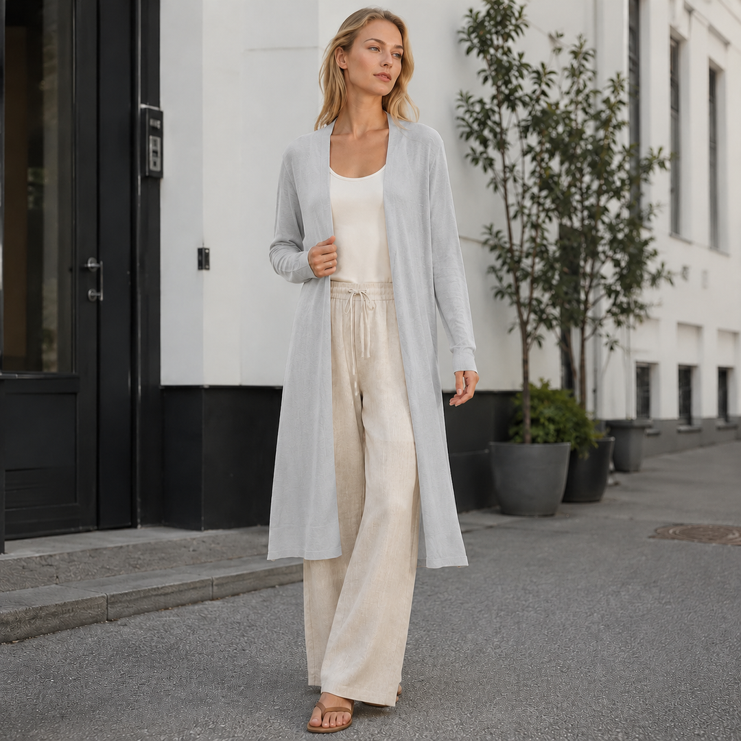 Detail of the luxurious, soft knit fabric of a women's long cozy cardigan. Premium quality.