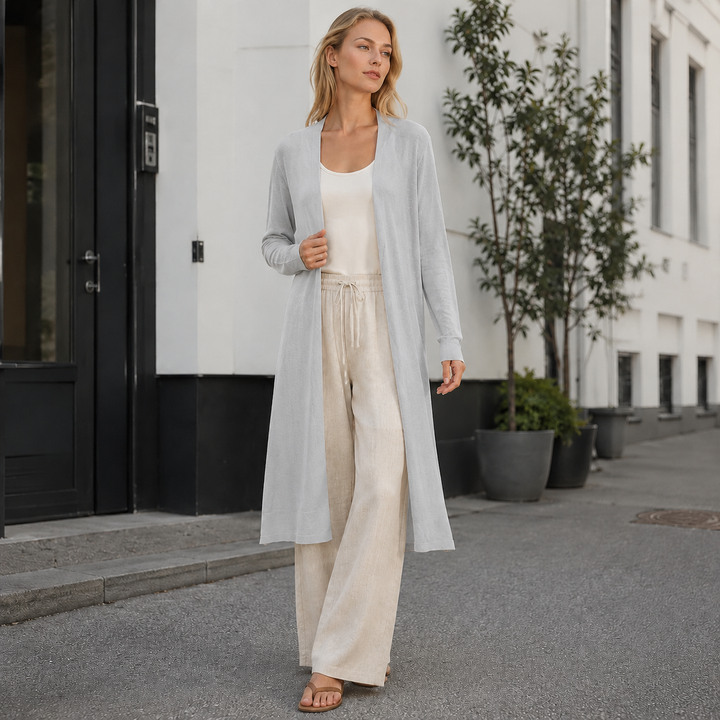 Detail of the luxurious, soft knit fabric of a women's long cozy cardigan. Premium quality.