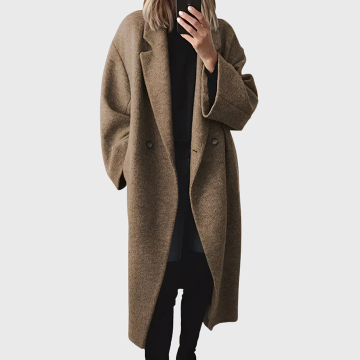Stylish women's grey longline overcoat. Cozy and elegant winter outerwear for an effortless, modern look.
