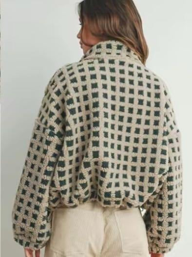 Front view of a women's cozy fleece jacket in a stylish check pattern, suitable for winter fashion.