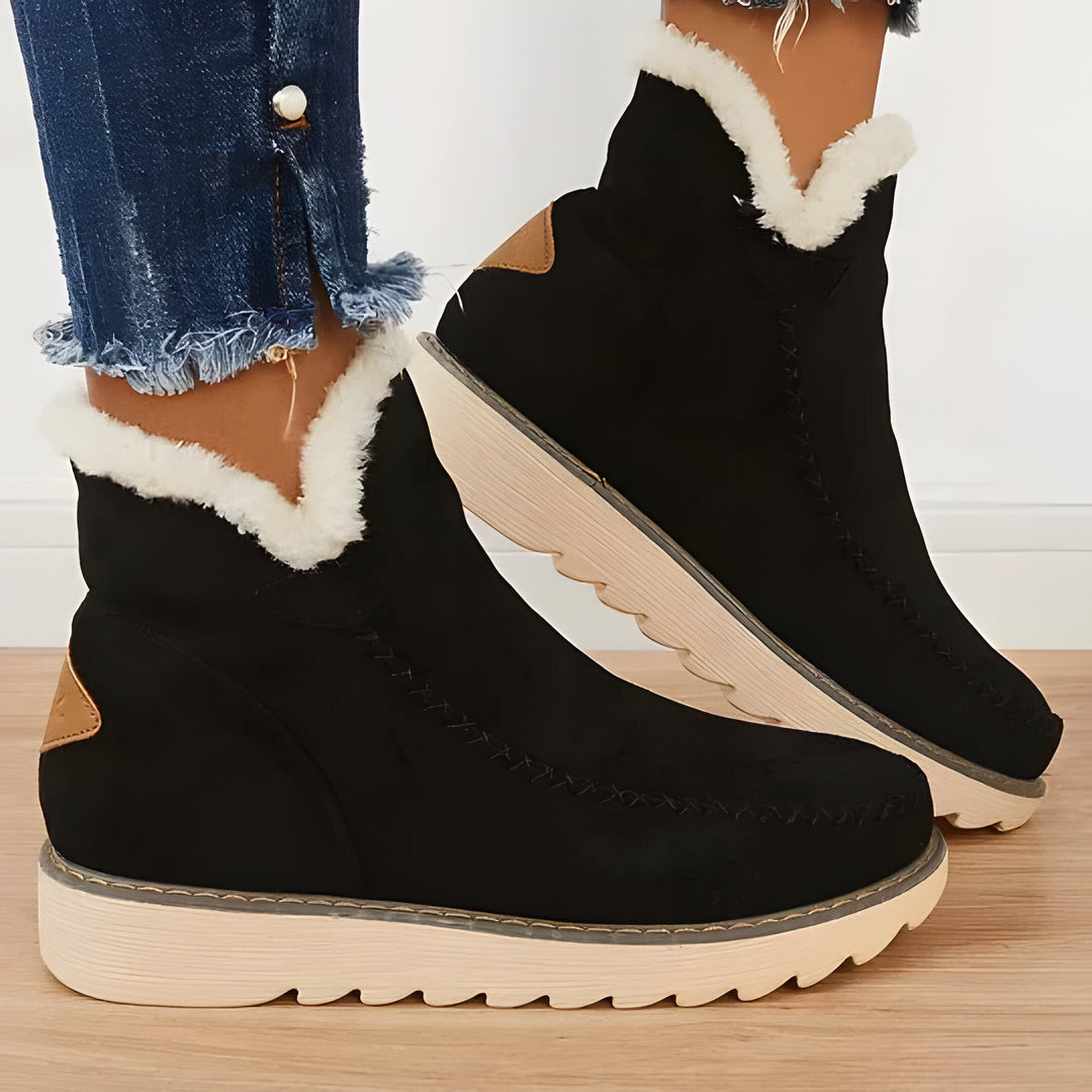 Plush-lined women's slip-on ankle boots, offering cozy warmth & comfort for stylish autumn & winter days.