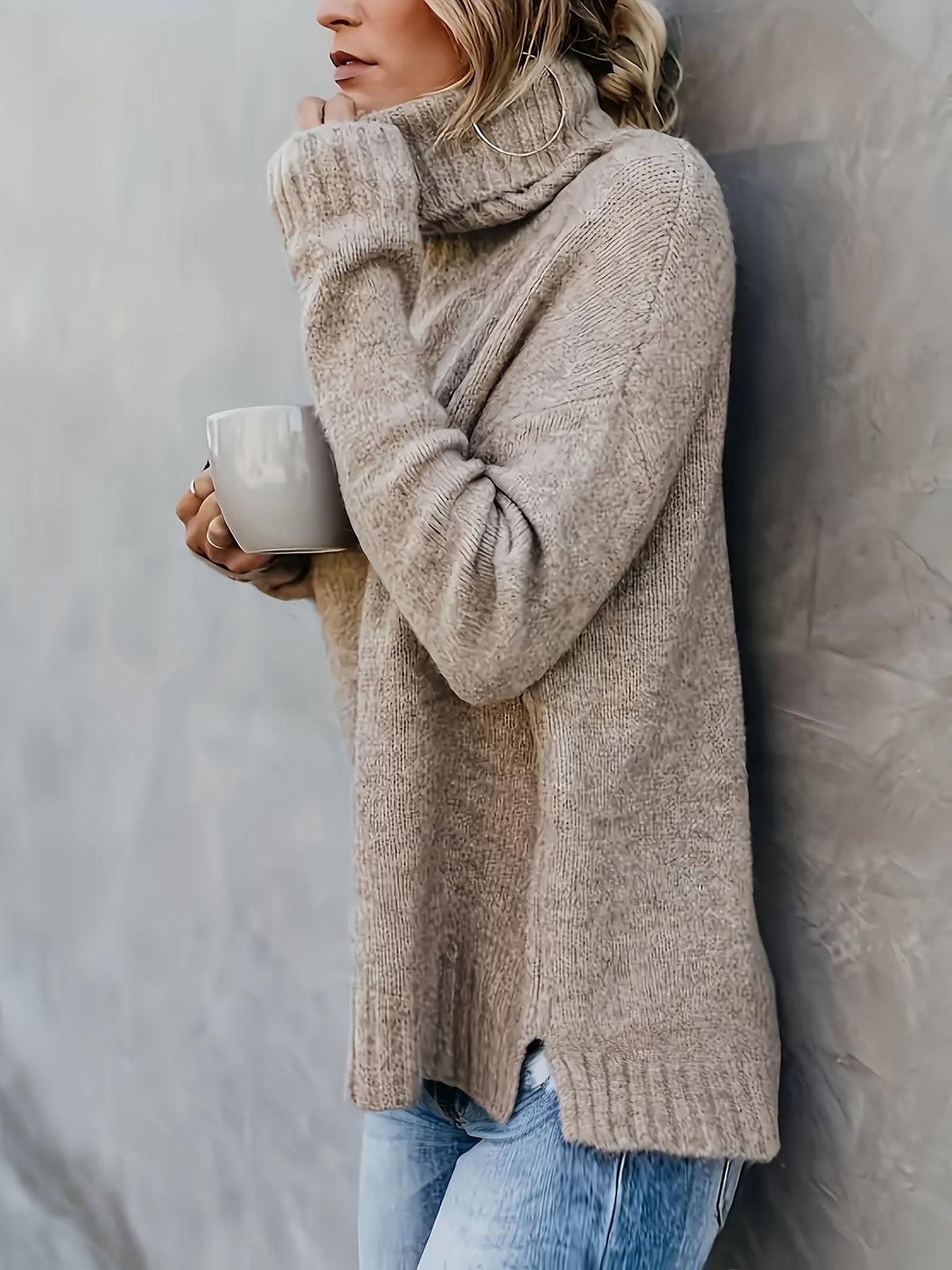 Relaxed fit women's turtleneck sweater, featuring a modern split hem, great for casual wear.