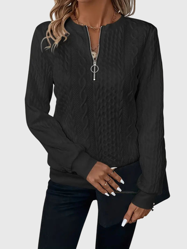 Chic women's cable knit pullover sweater, quarter-zip detail, for stylish comfort.