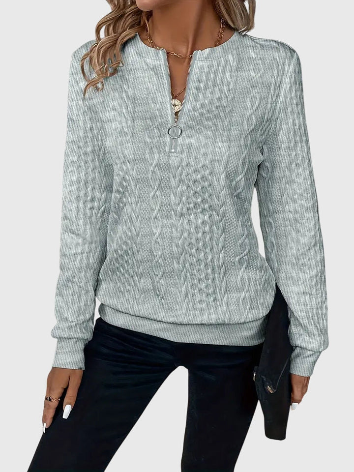 Breathable women's cable knit quarter-zip pullover, ideal for a smart casual look.