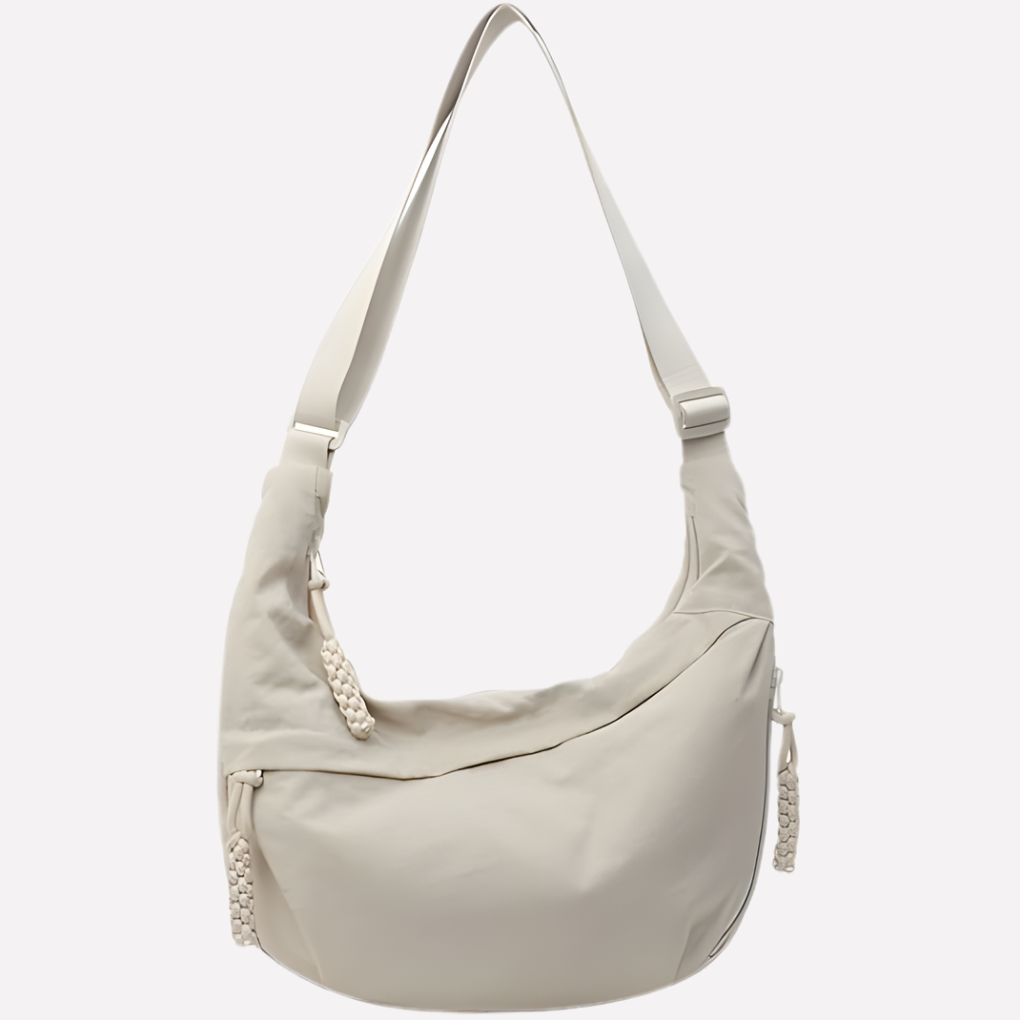 Women's crescent shoulder bag with elegant braided detail. A stylish everyday accessory.