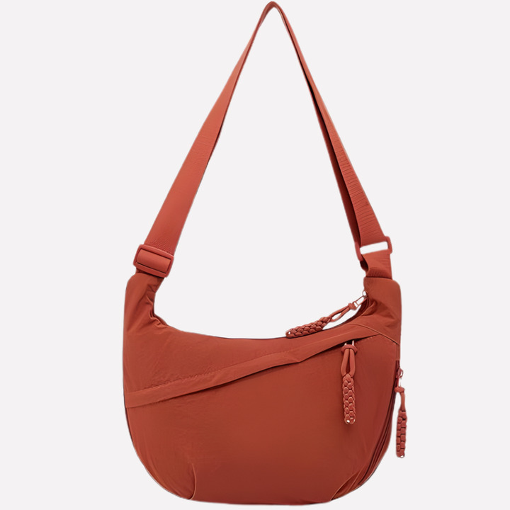 Women's stylish crescent shoulder bag, featuring a beautiful braided strap. An everyday essential.