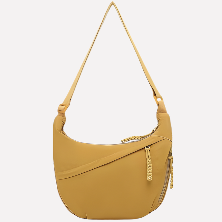 Contemporary women's crescent shoulder bag, accented with braided strap. A versatile fashion purse.