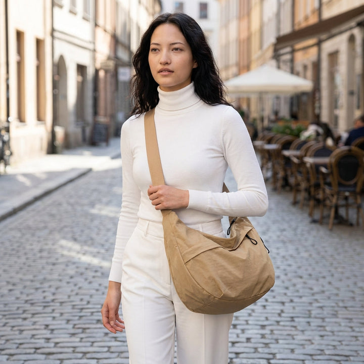 Chic women's crescent handbag, versatile with braided strap detail. Perfect for fashion.