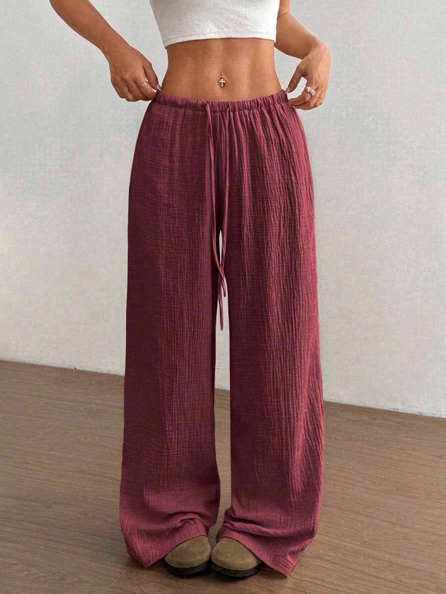 Flowy bohemian crinkle wide leg pants for women, featuring an adjustable drawstring waist.