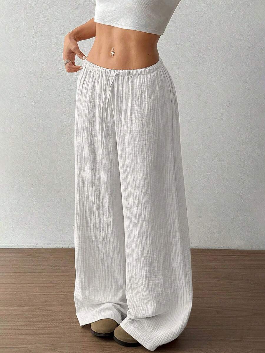 Comfortable women's wide leg crinkle pants with an elastic drawstring waist, perfect for relaxed casual wear.