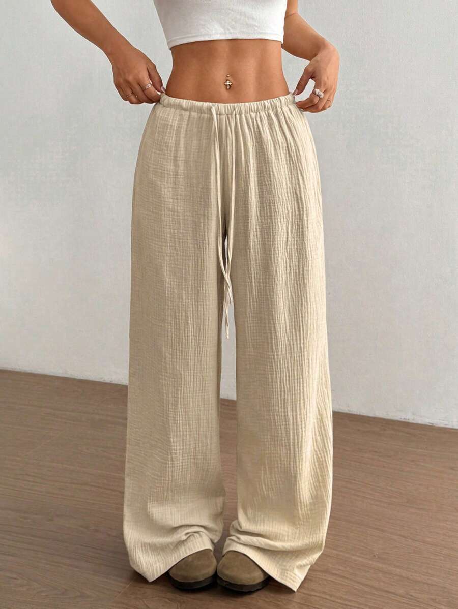 Bohemian women's wide leg crinkle pants, ideal for casual summer days with an adjustable drawstring waist.