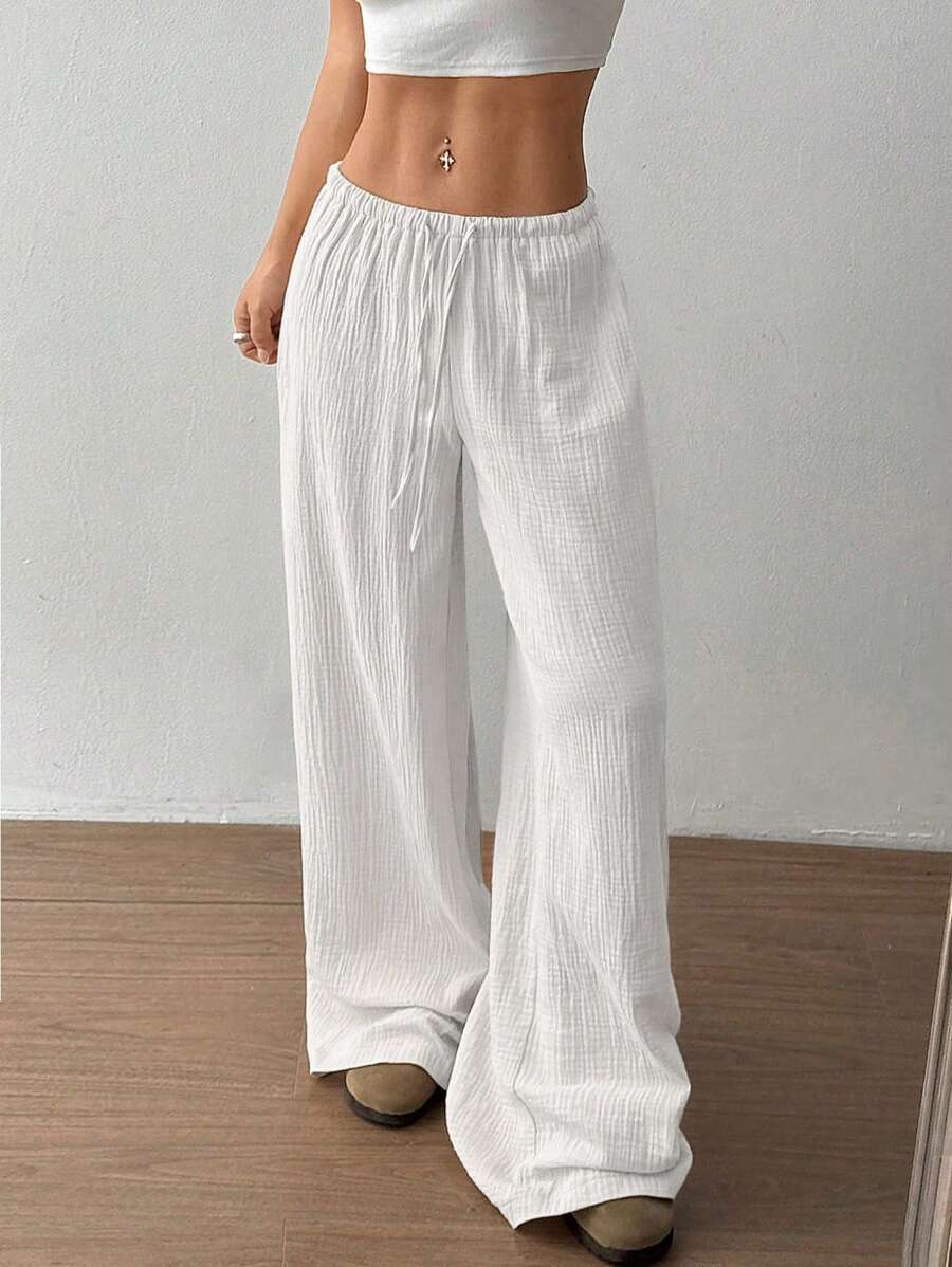 Close up of the comfortable elastic drawstring waist on women's crinkle wide leg summer pants.
