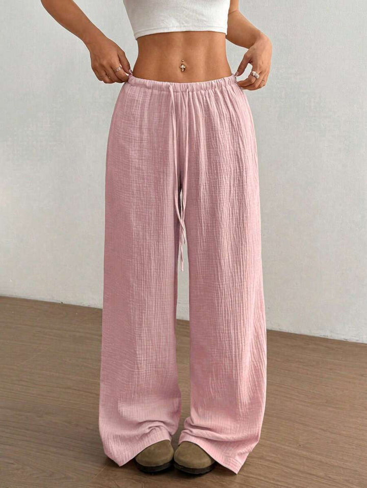 Textured crinkle fabric detail on women's wide leg pants, highlighting flowy summer style.