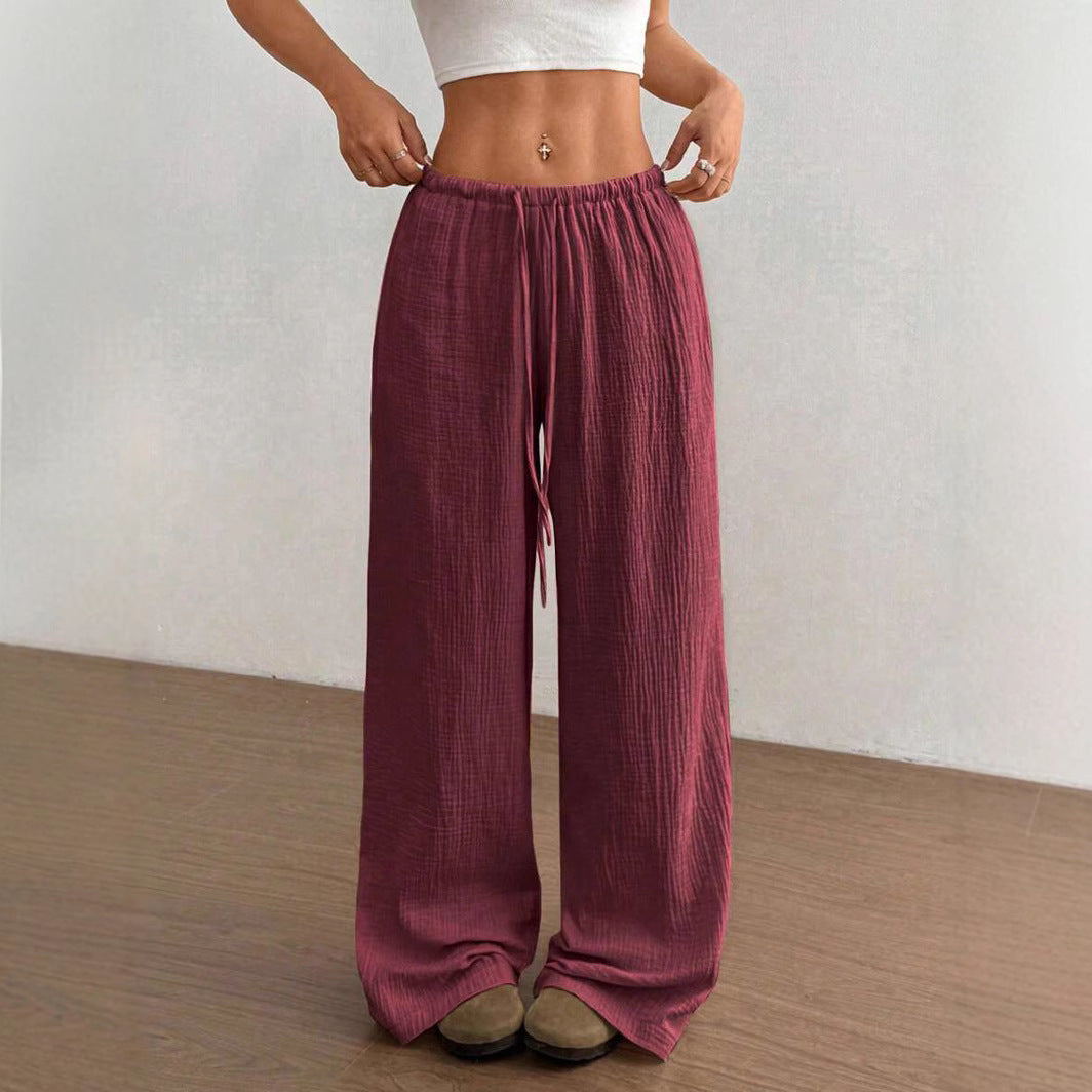 Versatile women's wide leg crinkle pants with a drawstring waist, perfect for casual or beach wear.