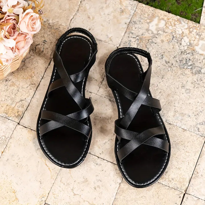 Casual women's criss-cross flat sandals, perfect slip-on footwear for warm days.