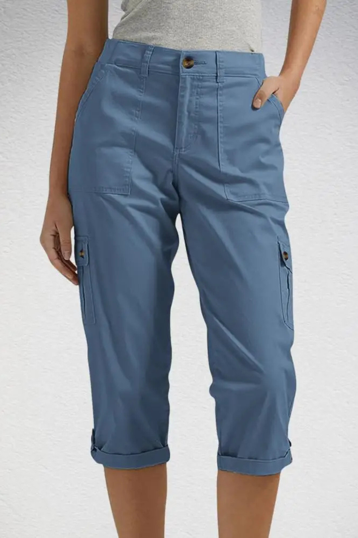 Woman wearing relaxed fit cropped cargo pants casually. Perfect utility capris for everyday adventures or travel.
