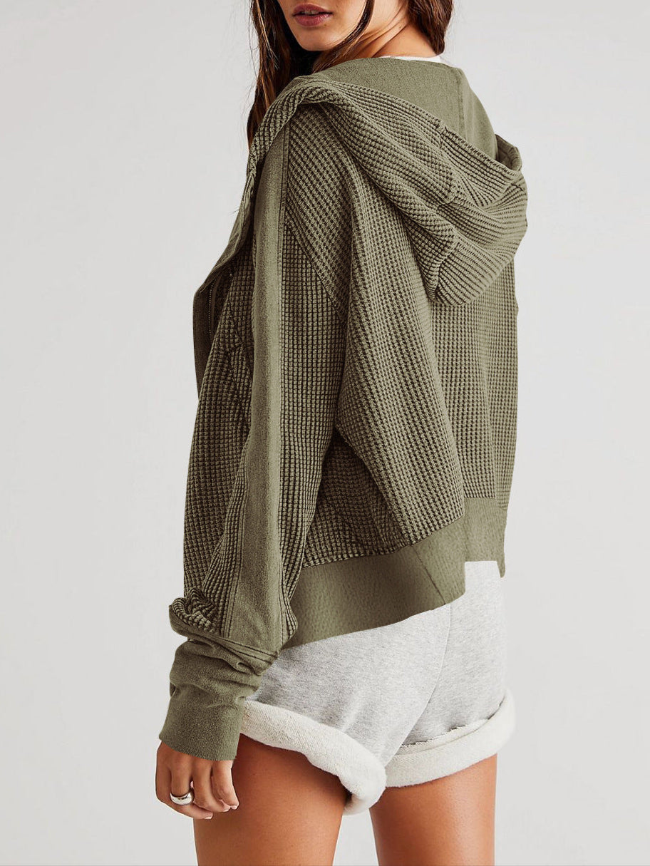 Close-up of the ribbed cuff on a women's cropped waffle-knit zip hoodie, comfy style