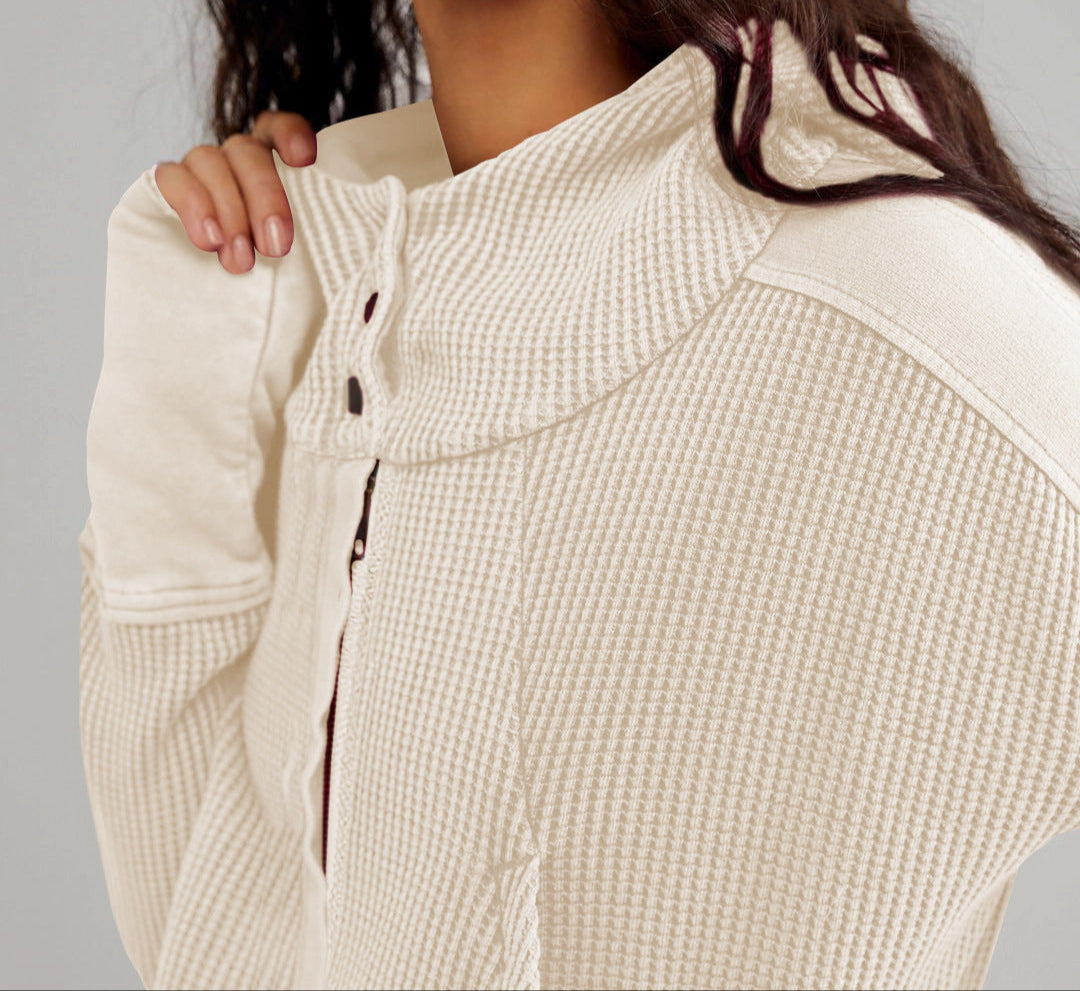 Woman lounging on a couch wearing a soft cropped waffle-knit zip hoodie, ultimate comfort