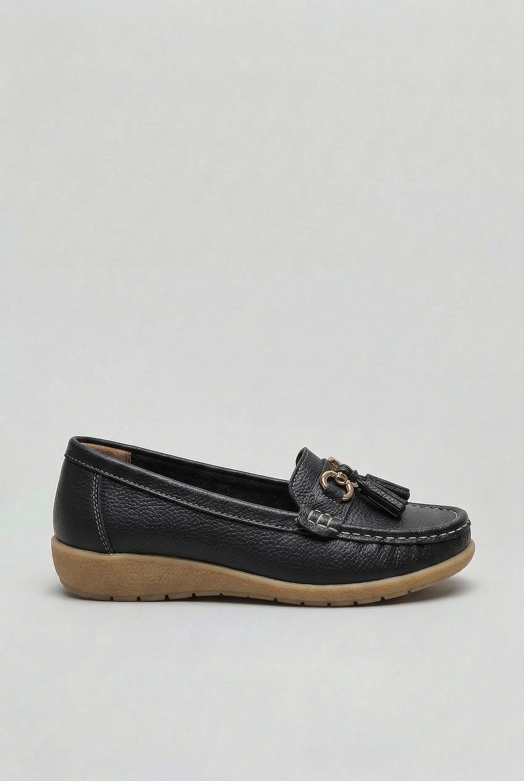 Woman relaxing in versatile cushioned loafers. Perfect everyday flat shoes for all-day comfort & style.