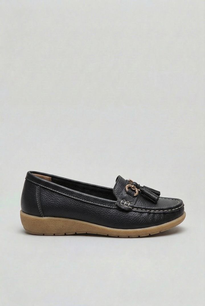 Woman relaxing in versatile cushioned loafers. Perfect everyday flat shoes for all-day comfort & style.