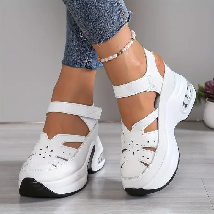 Women's cushioned wedge sandals with breathable cutouts & adjustable strap for summer comfort walking.