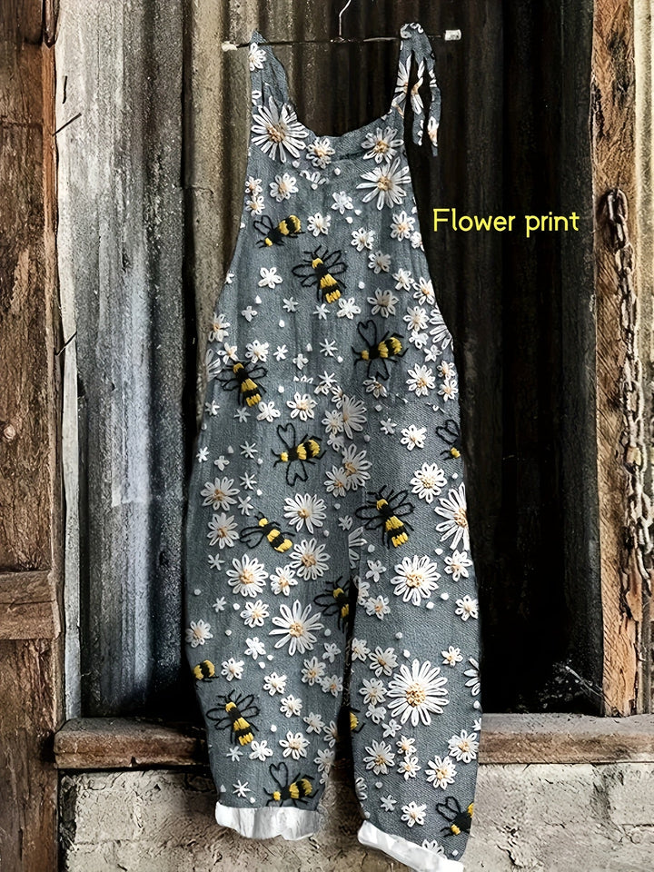 Women's tie-shoulder jumpsuit with pockets, showcasing a vibrant daisy bee print and wide legs.
