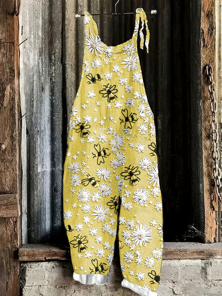 Women's tie-shoulder jumpsuit with a delightful daisy bee motif, practical pockets, and a stylish wide leg.