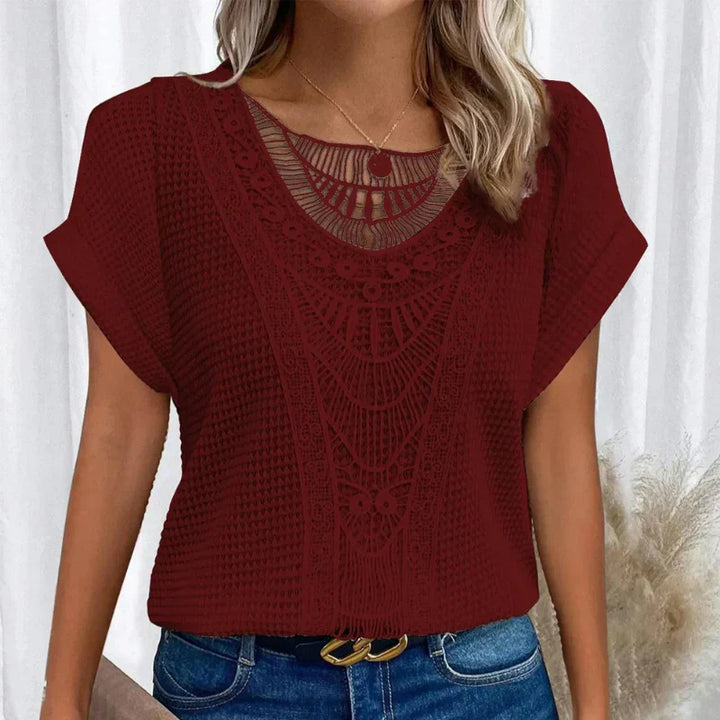 Textured crochet-style women's blouse, short sleeve, round neck. A stylish and breathable summer top.