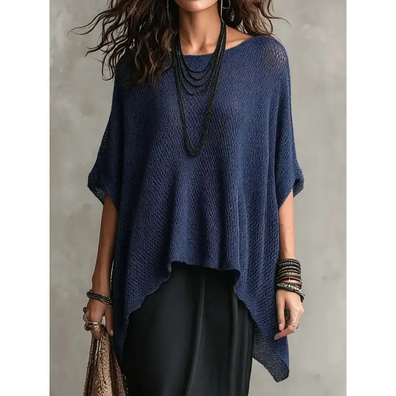 Textured knit women's draped poncho top, featuring an asymmetrical hem and comfortable loose fit. Versatile wear.