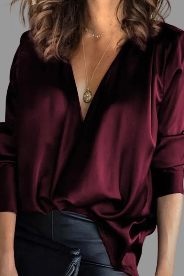 Shimmering women's draped V-neck blouse with long sleeves, relaxed fit, versatile for evening or casual chic.