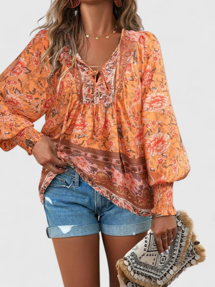 Feminine women's long sleeve floral peasant top, perfect for casual spring and summer looks.