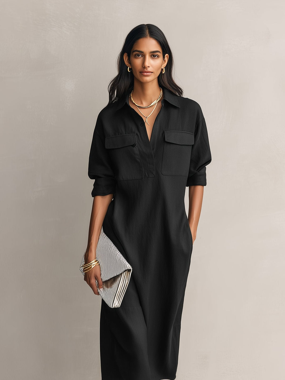 Relaxed fit women's black midi shirt dress. A versatile collared dress with elbow sleeves for casual comfort.