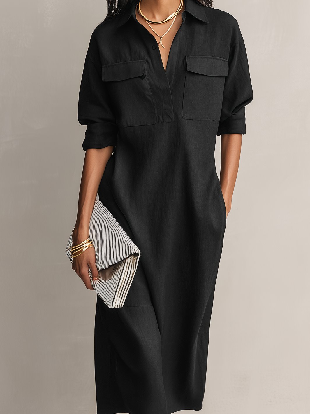 Stylish black midi shirt dress for women. Features a classic collar, elbow sleeves, and comfortable relaxed fit.