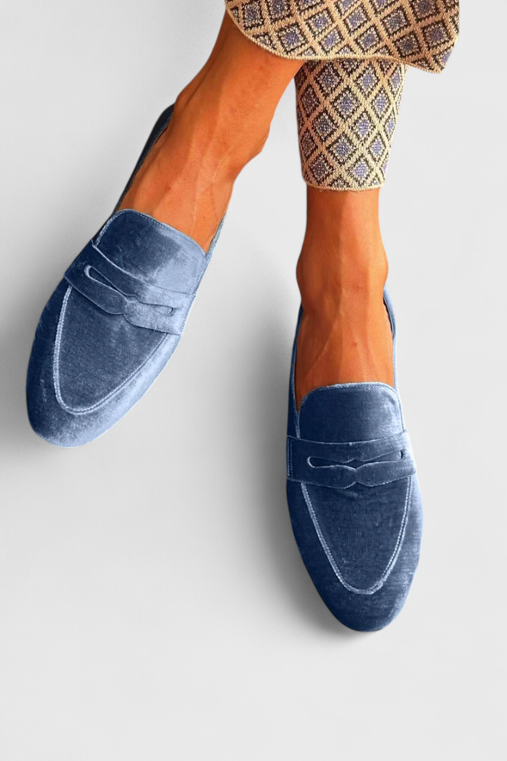 Stylish women's blue slip-on loafers. Comfortable, versatile flats for everyday wear, ideal for office or casual outings.