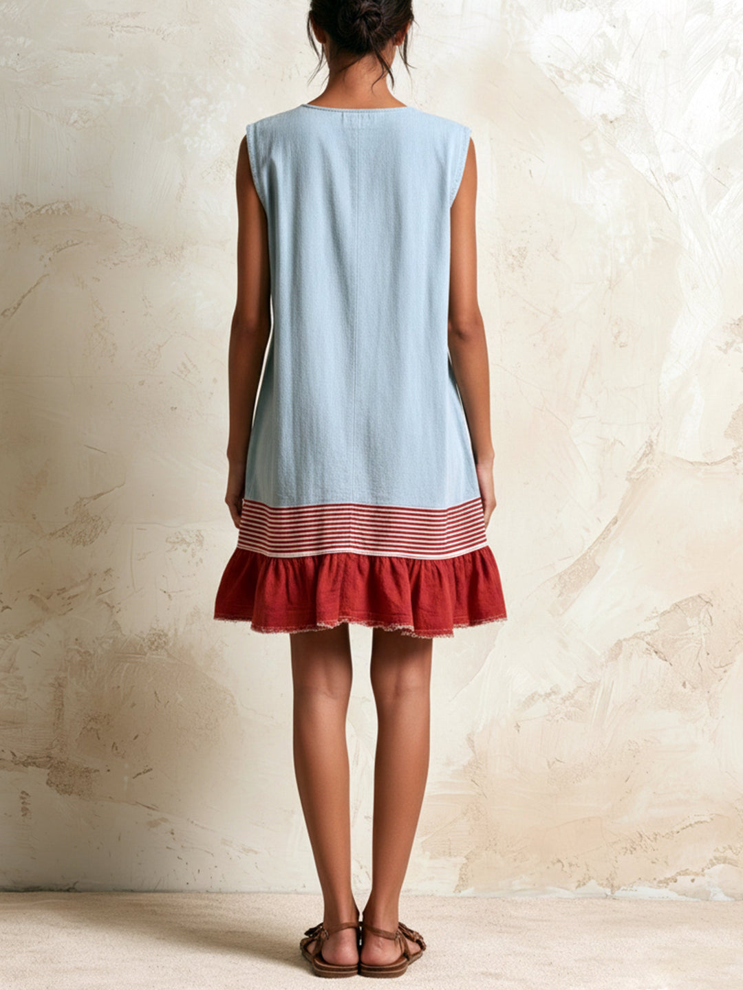 Effortless blue mini dress for women, featuring a sleeveless design and graceful tiered ruffle hem. Summer-ready.