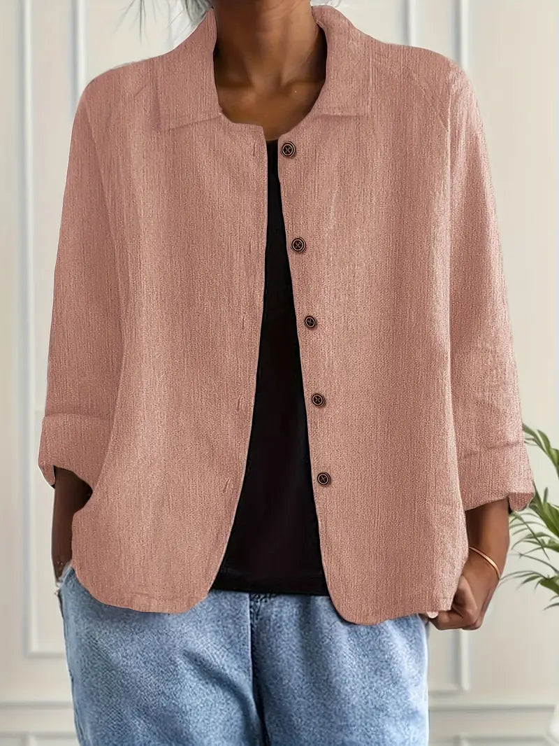 Stylish women's collared top with three-quarter sleeves, versatile for spring/summer fashion.