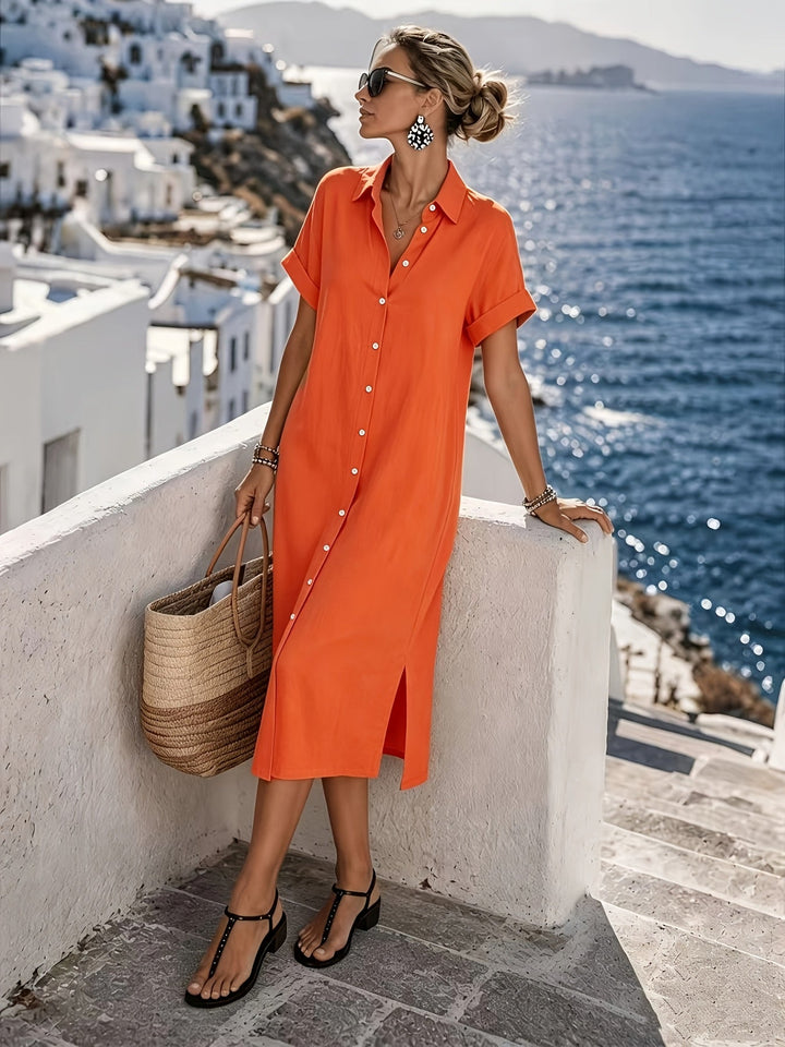 Women's elegant shirt dress with short sleeves and full button front, midi length.