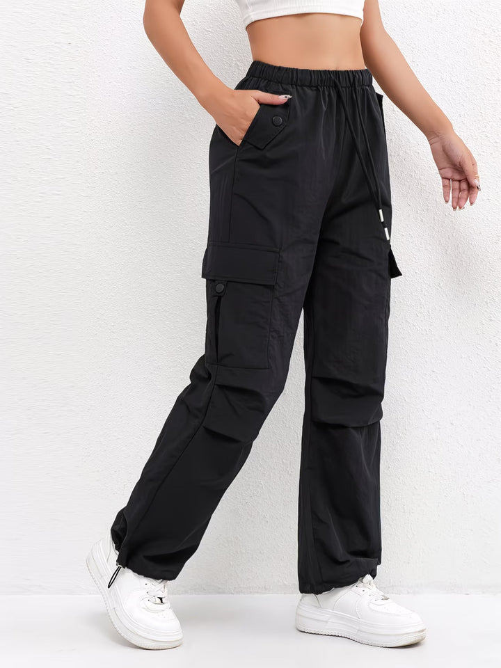 Comfortable women's parachute cargo pants, featuring a drawstring waist and adjustable hem for a relaxed fit.