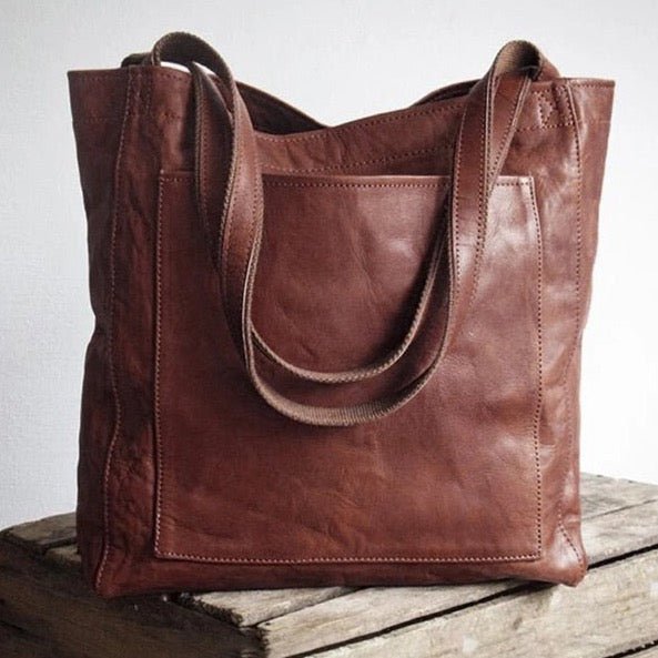 Chic coffee brown Women's Tote Bag. Fashionable shoulder handbag, ideal everyday women's accessory.
