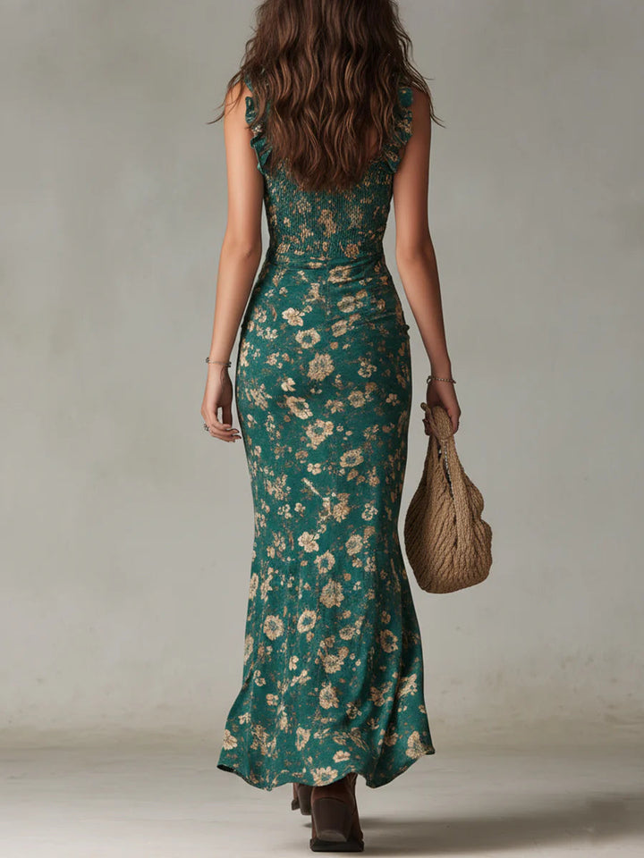 Model wearing a flowing green floral maxi sundress. Effortless boho style, ideal for beach vacations or summer events.