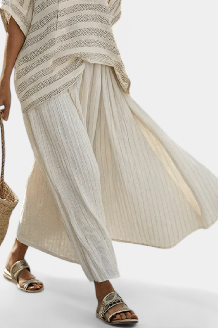 Boho chic women's multi-color striped batwing top & flowy maxi skirt set. Relaxed fit two-piece for summer fashion.