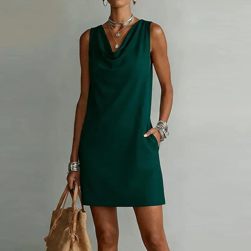 Women's effortless pocket mini dress, lightweight & stylish for summer. Features draped neckline & relaxed fit.